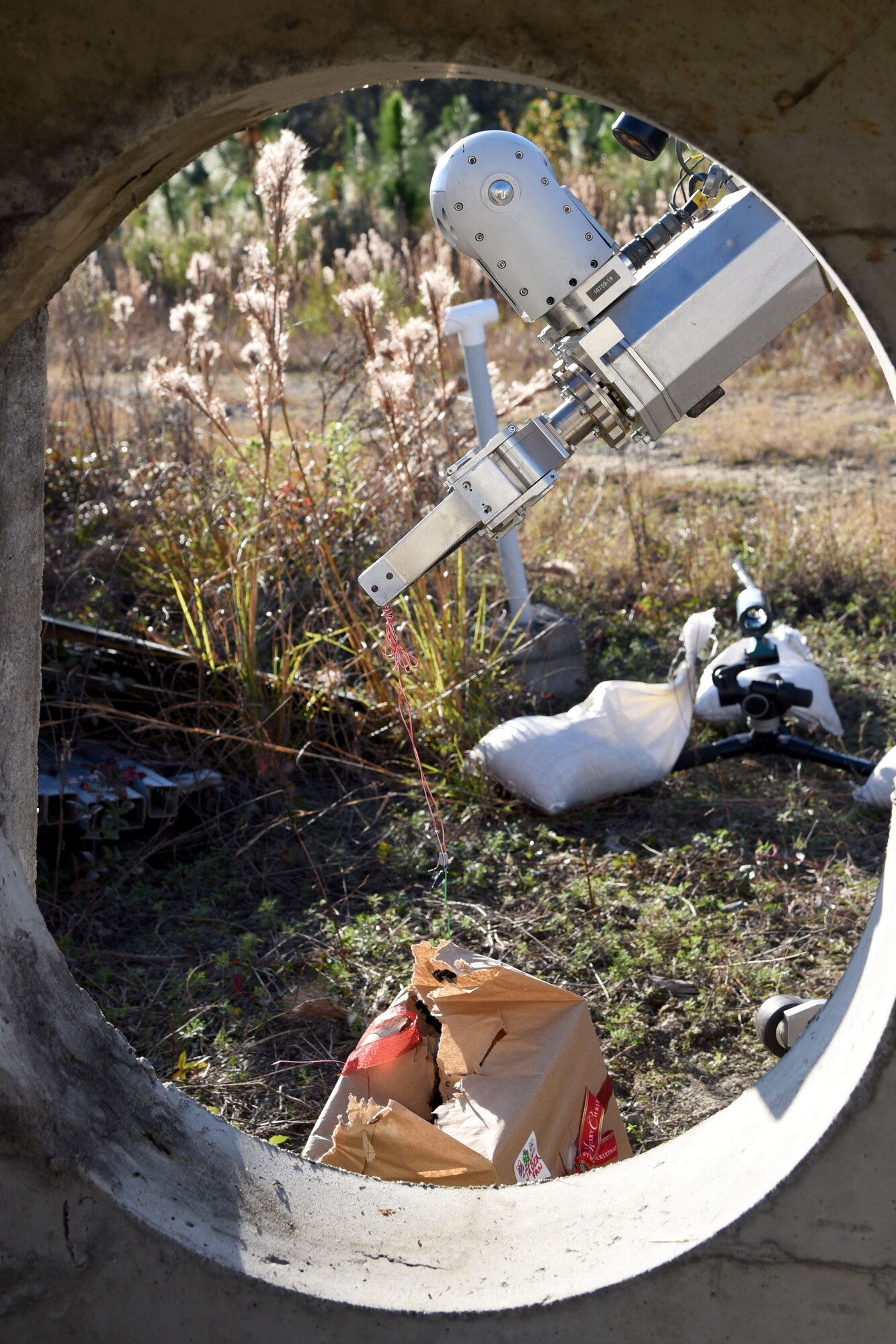 An Air Force medium sized robot extracts a string from a simulated improvised explosive device during a response training exercise, Dec. 21, 2017, at Moody Air Force Base, Ga. The EOD Airmen were evaluated on their ability to respond to a distress call, locate, identify and neutralize an improvised explosive device. (U.S. Air Force photo by Airman Eugene Oliver)