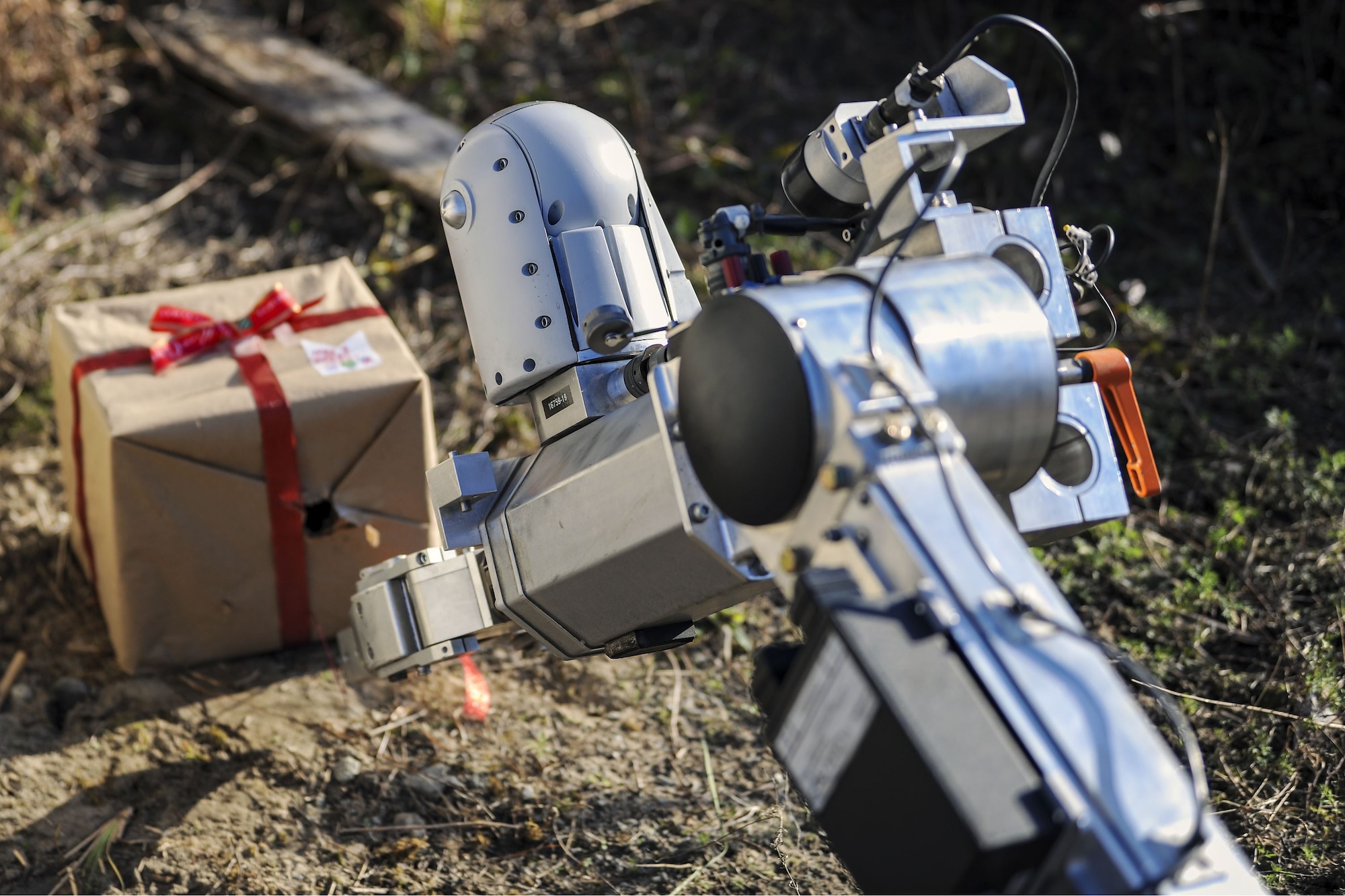 An Air Force medium sized robot approaches a simulated Improvised Explosive Device during a response training exercise, Dec. 21, 2017, at Moody Air Force Base, Ga. The EOD Airmen were evaluated on their ability to respond to a distress call, locate, identify and neutralize an improvised explosive device. (U.S. Air Force photo by Airman Eugene Oliver)