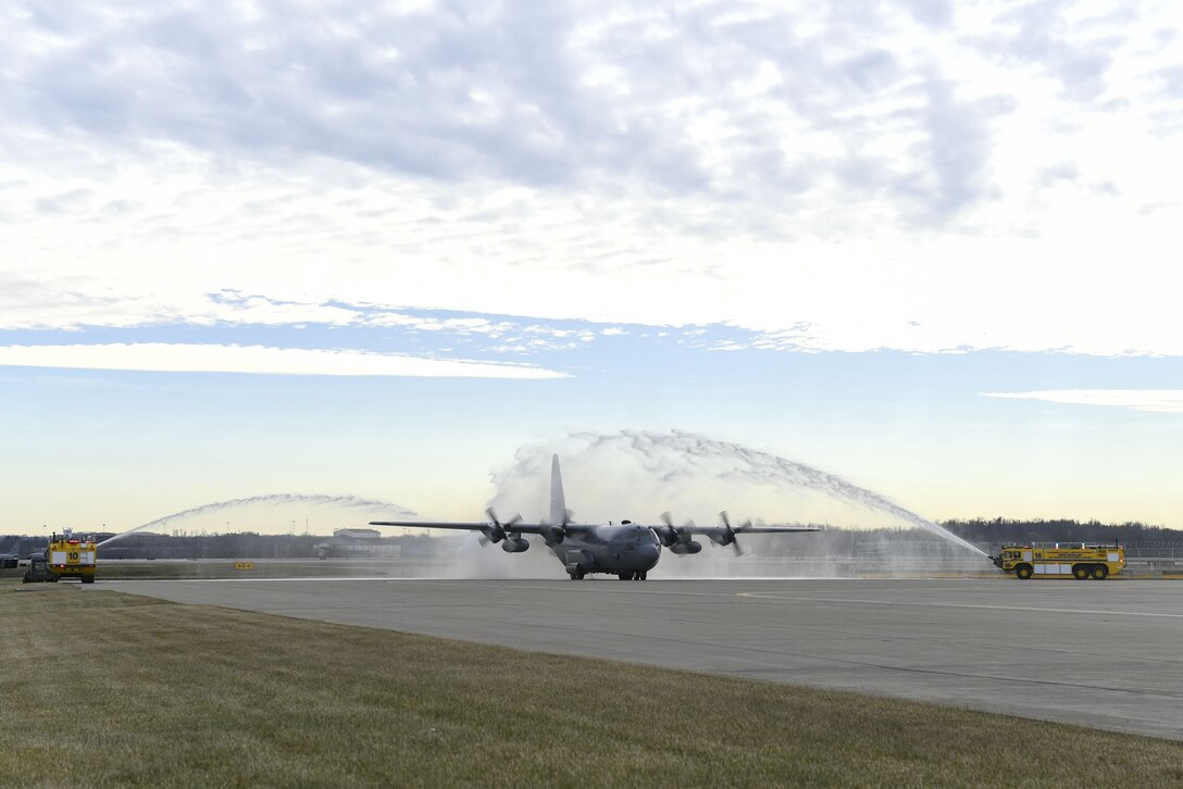 A C-130 Hercules assigned to the 911th Airlift Wing is sprayed by water as is passes by fire trucks at the Pittsburgh International Airport Air Reserve Station, Pennsylvania, December 21, 2017. The aircraft was returning from 758th Airlift Squadron flight engineer superintendent Chief Master Sgt. Bruce Bair’s Fini Flight, an Air Force tradition to honor the last flight of a member’s career. (U.S. Air Force photo by Senior Airman Beth Kobily)