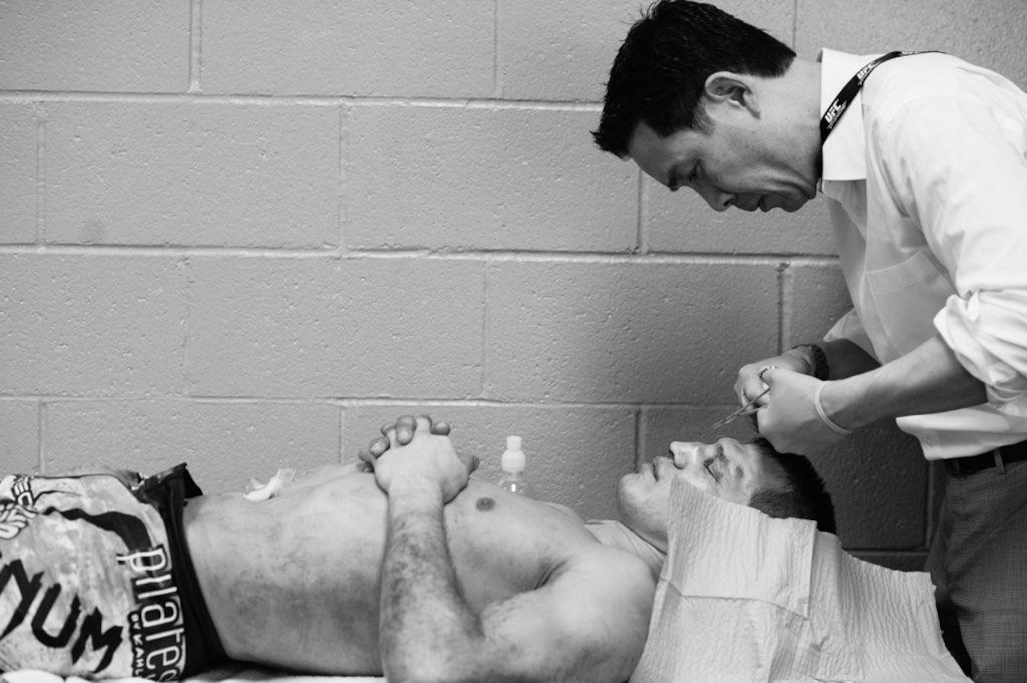 Dr. (Col.) Gregory Hsu, right, treats facial injuries on UFC fighters following their bouts in the octagon. Hsu is an ophthalmologist who also serves in the Air Force as the Individual Mobilization Augmentee to the Pacific Air Forces Surgeon General.