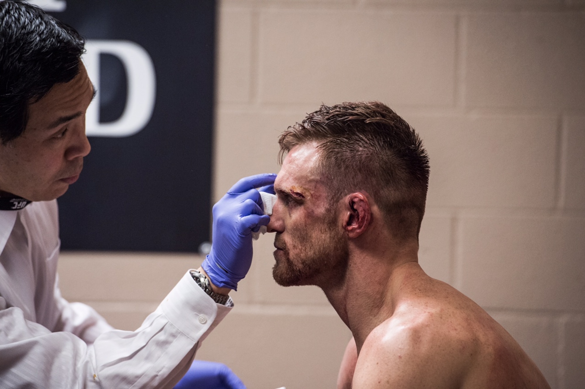 Dr. (Col.) Gregory Hsu, right, treats facial injuries on UFC fighters following their bouts in the octagon. Hsu is an ophthalmologist who also serves in the Air Force as the Individual Mobilization Augmentee to the Pacific Air Forces Surgeon General.