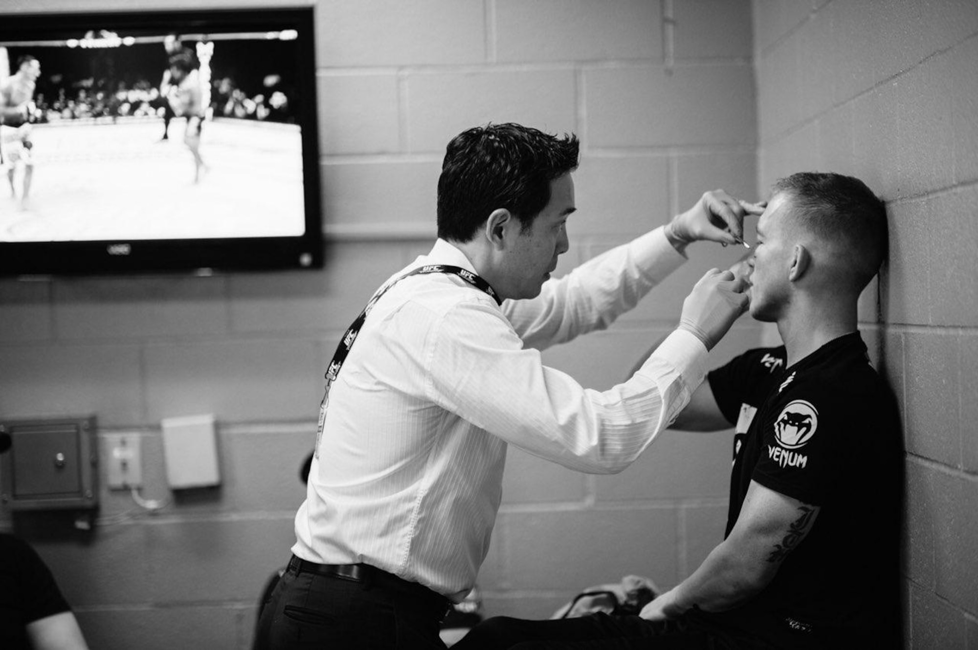 Dr. (Col.) Gregory Hsu, right, treats facial injuries on UFC fighters following their bouts in the octagon. Hsu is an ophthalmologist who also serves in the Air Force as the Individual Mobilization Augmentee to the Pacific Air Forces Surgeon General.