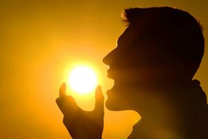 An airman pretends to eat the sun.