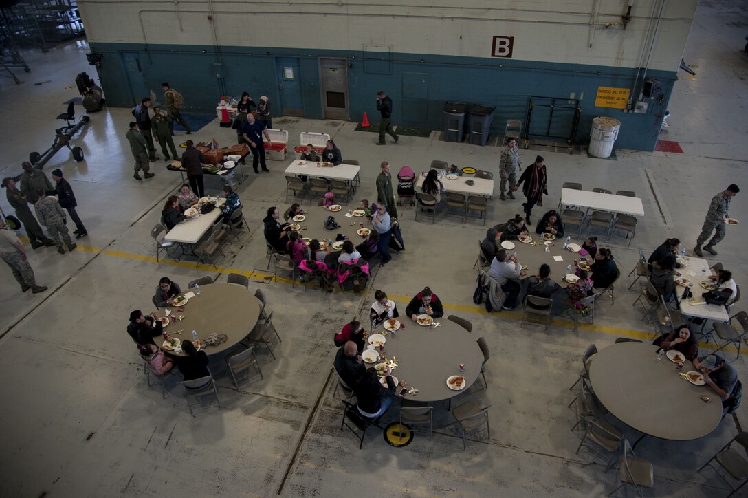 Visitors from the University of New Mexico children's hospital, eat lunch with Airmen from the 58th Special Operations Wing at Kirtland Air Force Base, N.M., Dec. 21. The Children's Cancer Fund of New Mexico, partnered with the 58th Special Operations Wing to host the event for the children and their families.