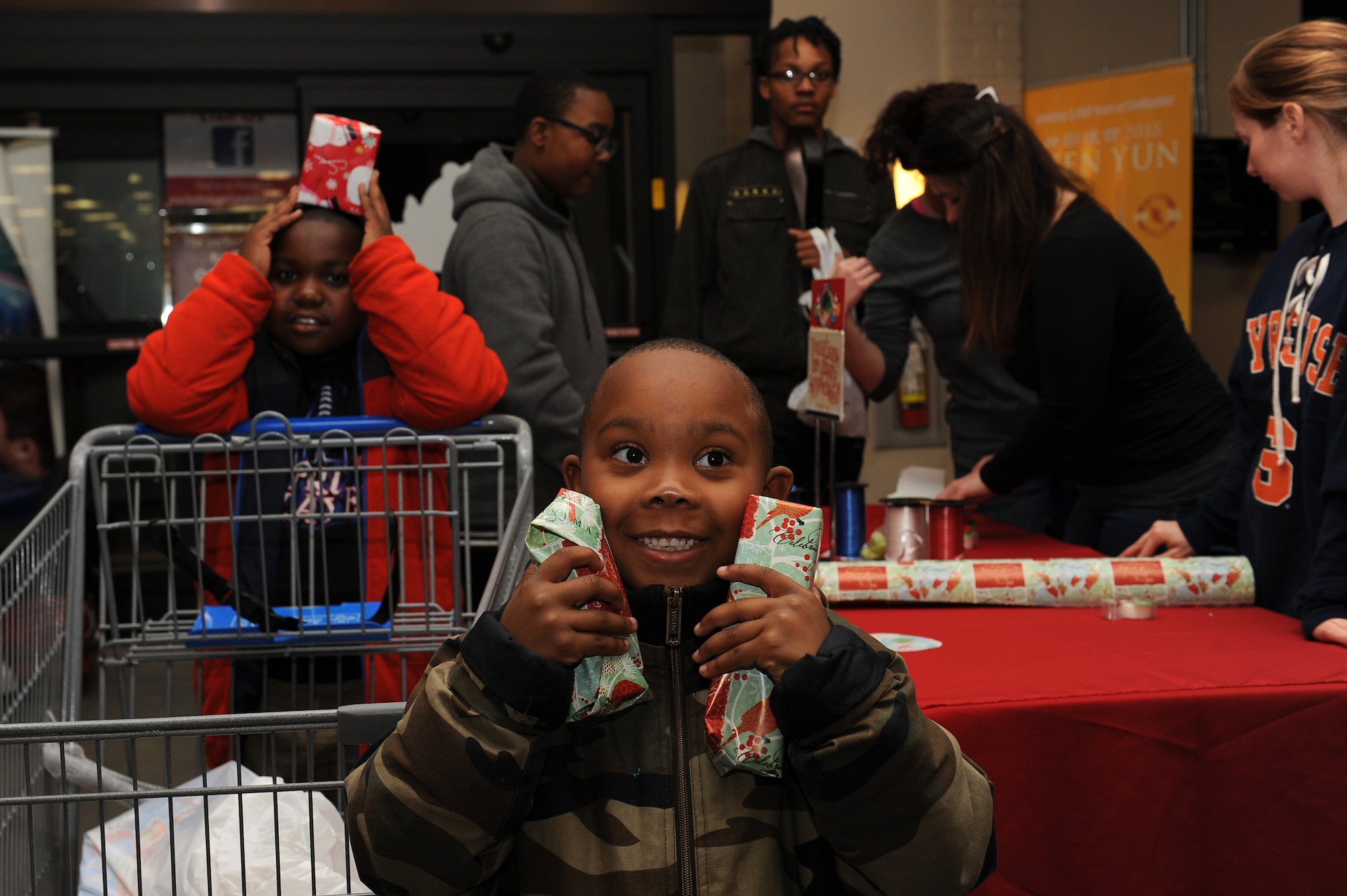 Chase Frost, age 8 and Noah Frost, age 6, local youth with The Up Center’s Team Up mentoring program, a non-profit organization in Hampton Roads, show-off gifts they purchased during the “Shop with a Cop” event at Joint Base Langley-Eustis, Va., Dec. 19, 2017.