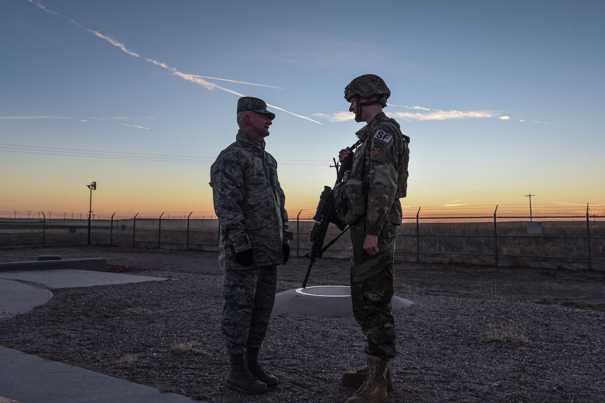 Chief Master Sgt. Thomas Good, 20th Air Force command chief, speaks with Airman 1st Class Bradley  Novack, after gaining access to a launch facility, Dec. 19, 2017, in the 90th Missile Wing missile complex. Good visited the launch facility and remained overnight at a missile alert facility, to get some face to face interaction with Airmen in the field. (U.S. Air Force photo by Airman 1st Class Braydon Williams)