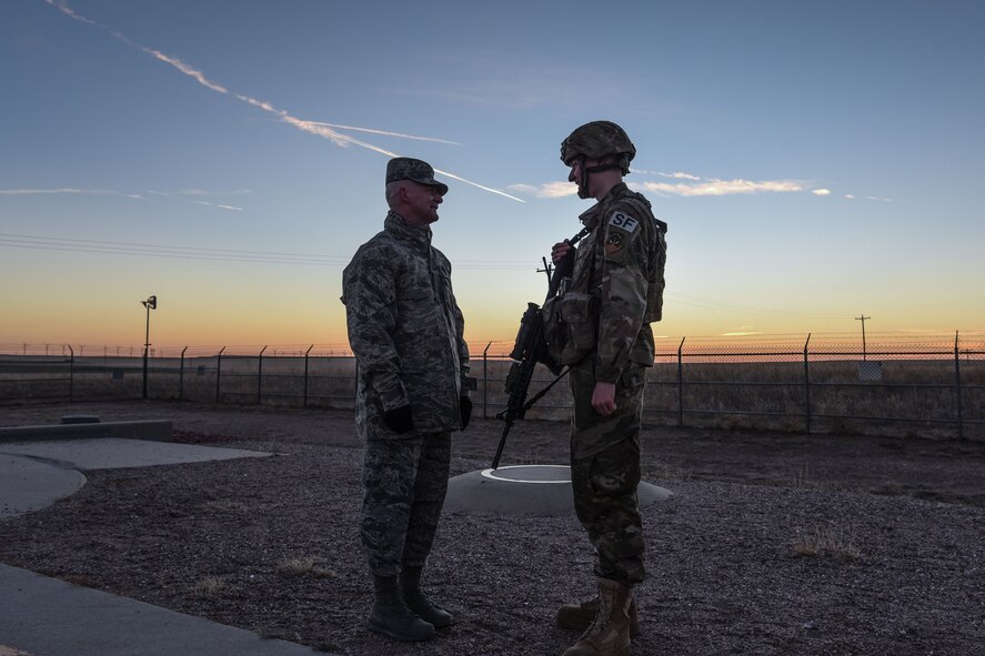 Chief Master Sgt. Thomas Good, 20th Air Force command chief, speaks with Airman 1st Class Bradley  Novack, after gaining access to a launch facility, Dec. 19, 2017, in the 90th Missile Wing missile complex. Good visited the launch facility and remained overnight at a missile alert facility, to get some face to face interaction with Airmen in the field. (U.S. Air Force photo by Airman 1st Class Braydon Williams)