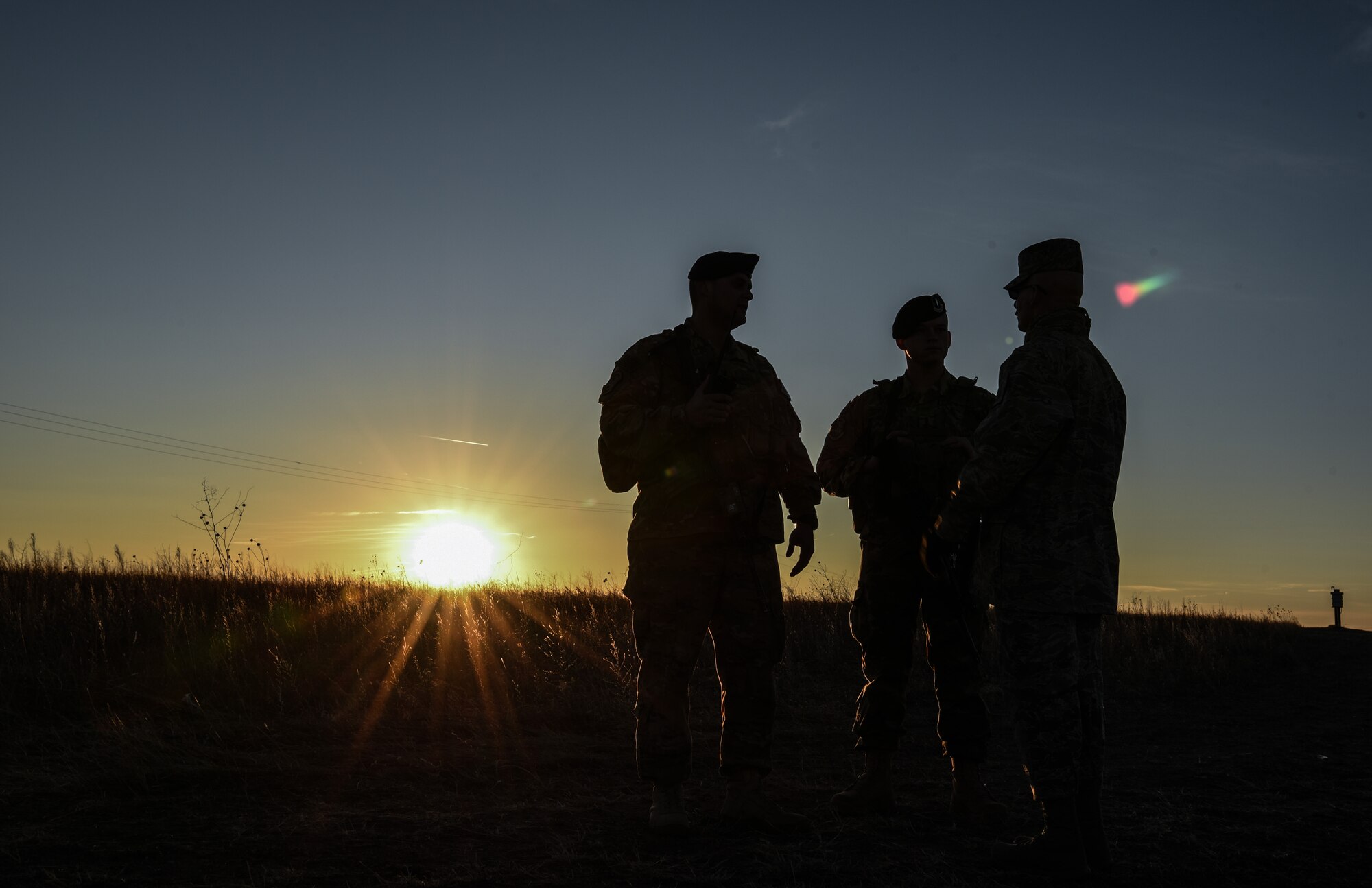 Chief Master Sgt. Thomas Good, 20th Air Force command chief, speaks with two Security Forces Airmen while waiting for approval to enter a launch facility Dec. 19, 2017, in the 90th Missile Wing missile complex. Good visited the launch facility and remained overnight at a missile alert facility, to get some face to face interaction with Airmen in the field. (U.S. Air Force photo by Airman 1st Class Braydon Williams)