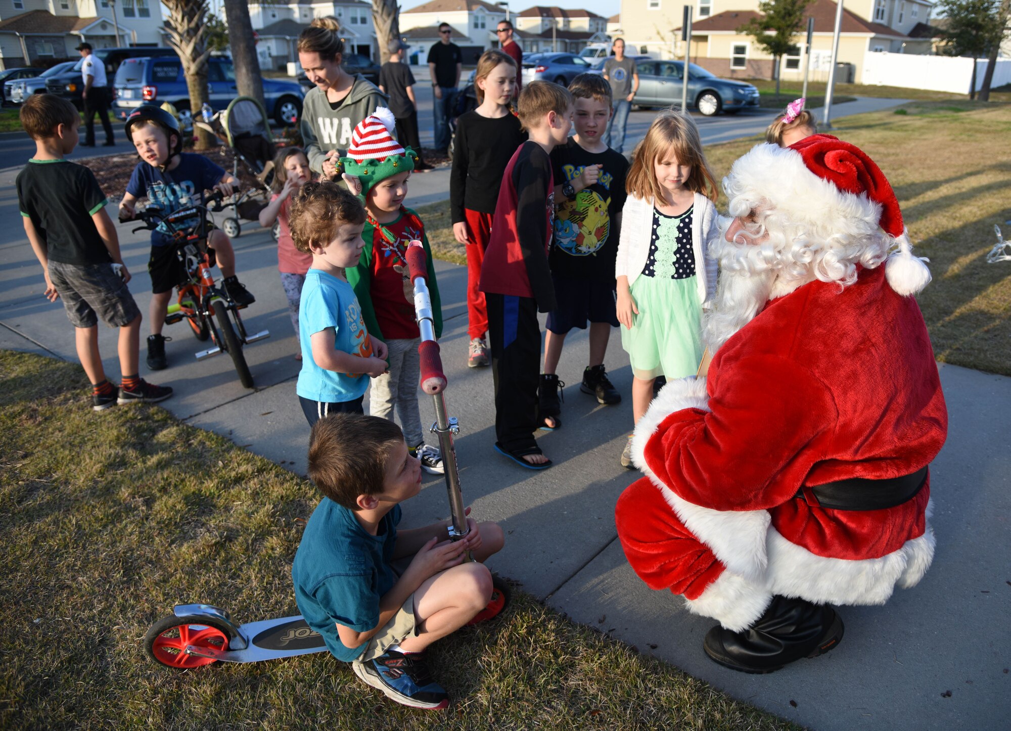 Santa visits with children in Bay Ridge housing Dec. 21, 2017, on Keesler Air Force Base, Mississippi. Santa rode in a fire truck as he drove through each housing area to spread Christmas cheer to Airmen and their families. (U.S. Air Force photo by Kemberly Groue)