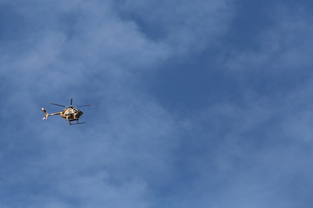 An Afghan Air Force MD-530 helicopter flies above Camp Shroabak, Afghanistan as Afghan tactical air controllers conduct simulated airstrike training Dec. 18, 2017. Several ATACs worked with coalition advisors to direct strikes onto notional Taliban targets in preparation for upcoming operations in Helmand province. On the battlefield, ATACs routinely call in air-based fire support to destroy enemy targets, allowing for more freedom of movement and enhanced security for Afghan forces. (U.S. Marine Corps photo by Sgt. Lucas Hopkins)