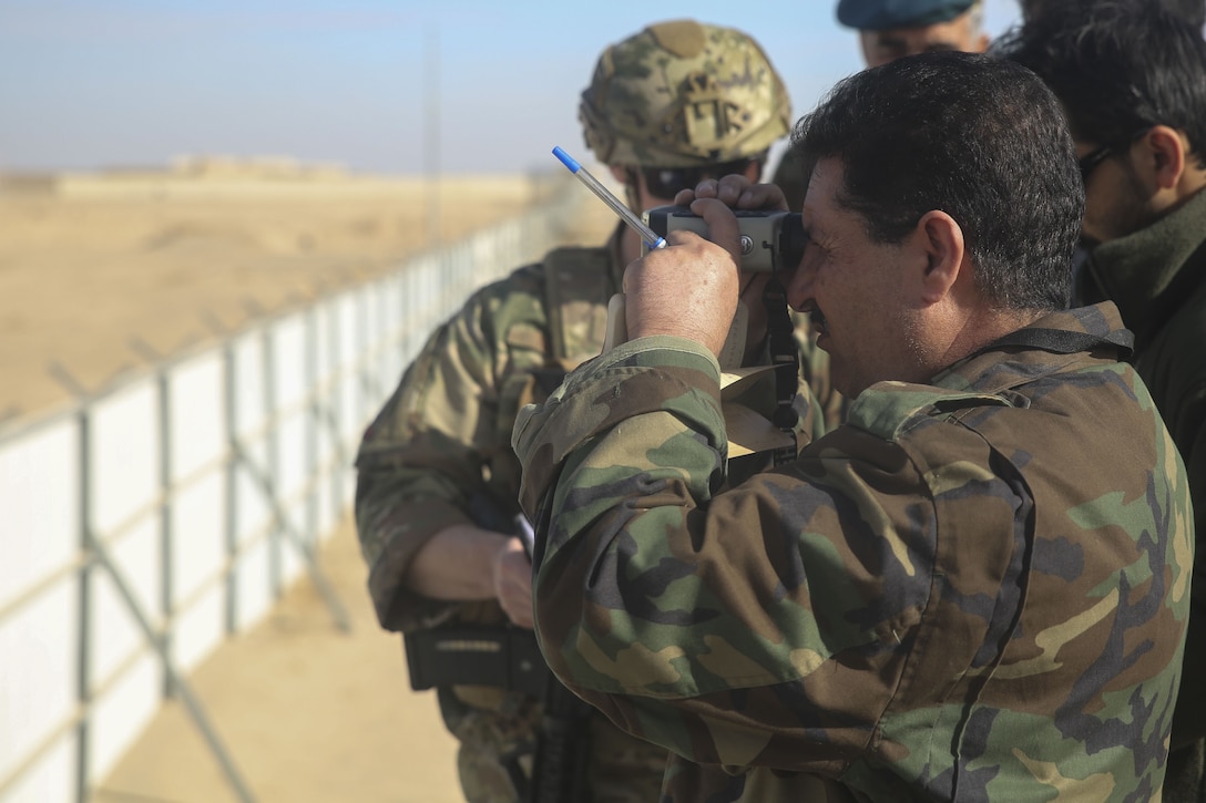 An Afghan Air Force tactical air controller scouts notional targets for MD-530 helicopters during an ATAC training exercise at Camp Shorabak, Afghanistan, Dec. 18, 2017. Several ATACs worked to enhance their aircraft directing skills with assistance from coalition advisors in preparation for future operations in Helmand province. Tactical air controllers often travel with ground force elements on the battlefield to direct airstrikes onto Taliban targets, allowing for better maneuver and safety of Afghan forces. (U.S. Marine Corps photo by Sgt. Lucas Hopkins)