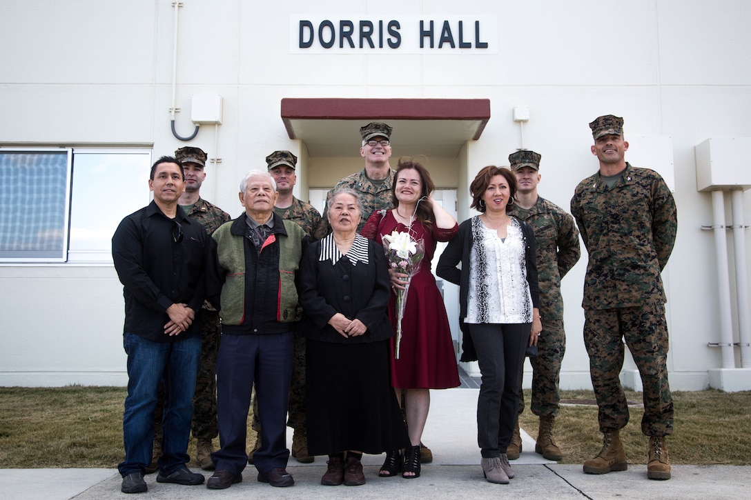 Colonel Giles R. Boyce, the commanding officer for Headquarters Battalion, 3rd Marine Division, stands with Marines from the 3rd Marine Division and Okinawan guests in front of Dorris Hall, Camp Courtney, Okinawa, Japan, after touring through the staff non-commissioned officer barracks on Dec. 22, 2017. Dorris Hall is named after the Navy Cross recipient, Staff Sgt. Claude H. Dorris, a squad leader with the Combined Action Program during the Vietnam War, who went above and beyond the call of duty.