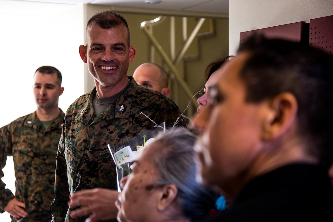 Colonel Giles R. Boyce, the commanding officer for Headquarters Battalion, 3rd Marine Division, welcomes Okinawan guests into Dorris Hall on Dec. 22, 2107. Dorris Hall is named after the Navy Cross recipient Staff Sgt. Claude H. Dorris, a squad leader with the Combined Action Program during the Vietnam War, who went above and beyond the call of duty.