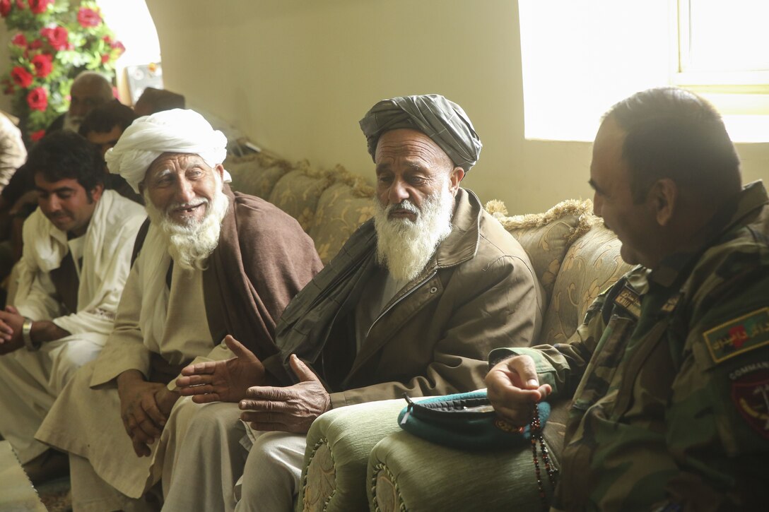 An Afghan tribal elder from Gereshk, Afghanistan area speaks with Afghan National Army Maj. Gen. Wali Mohammed Ahmadzai, the commanding general of 215th Corps, near Gereshk, Dec. 14, 2017. Key leaders with Helmand-based Afghan National Defense and Security Forces and U.S. Marine advisors with Task Force Southwest gathered with soldiers from 3rd Brigade, 215th Corps and tribal elders to discuss recent improvements in security and develop further plans for Operations Maiwand Nine and Ten. By executing sequential missions, Afghan forces such as 215th Corps, 505th Zone National Police, the National Directorate of Security and other elements are building pressure on the Taliban in districts surrounding Lashkar Gah. (U.S. Marine Corps photo by Sgt. Lucas Hopkins)