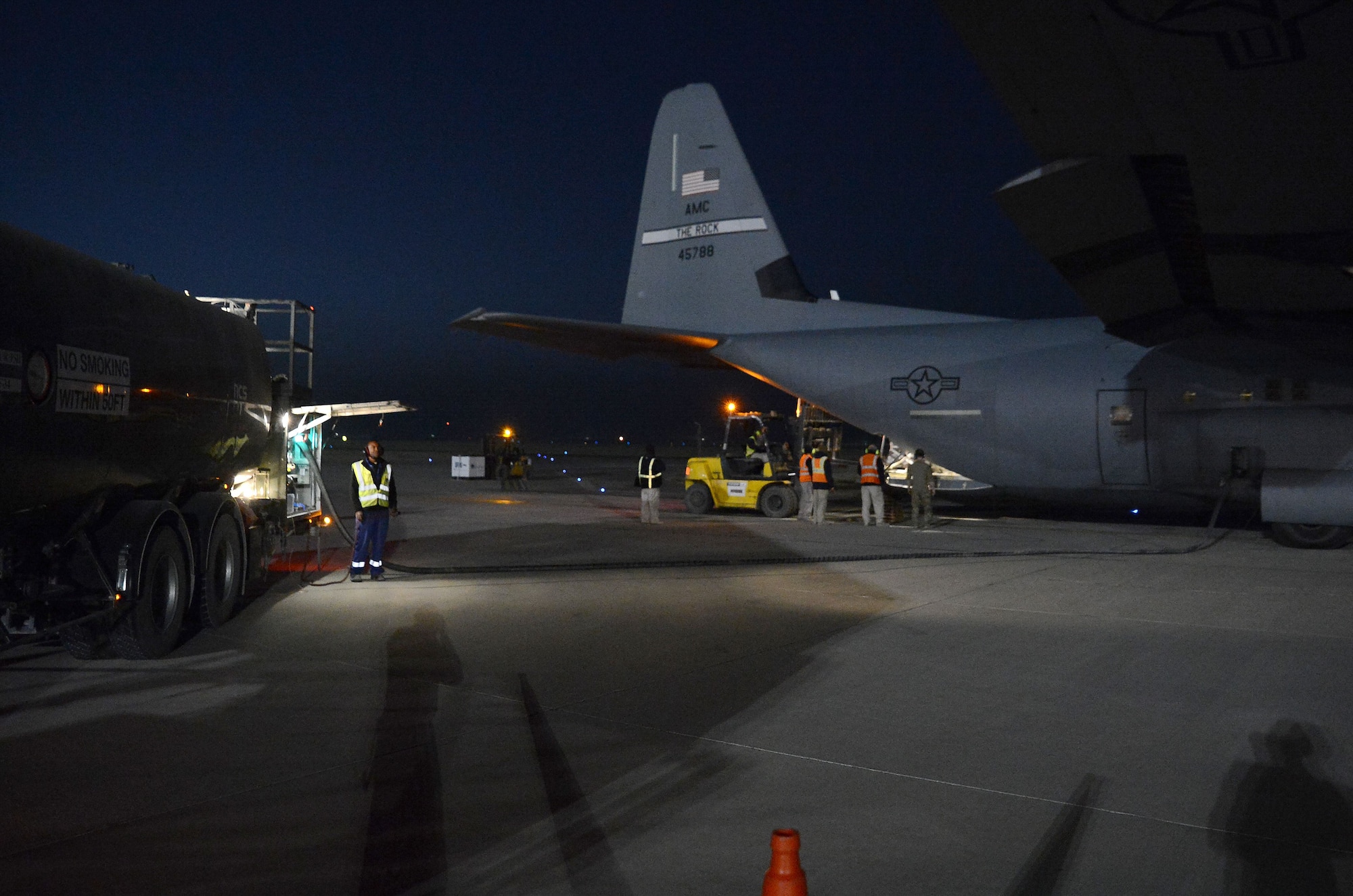 A C-130J Super Hercules from the 774th Expeditionary Airlift Squadron receives fuel from a fuel truck during a wet-wing mission Dec. 10, 2017 at Kandahar Airfield, Afghanistan.