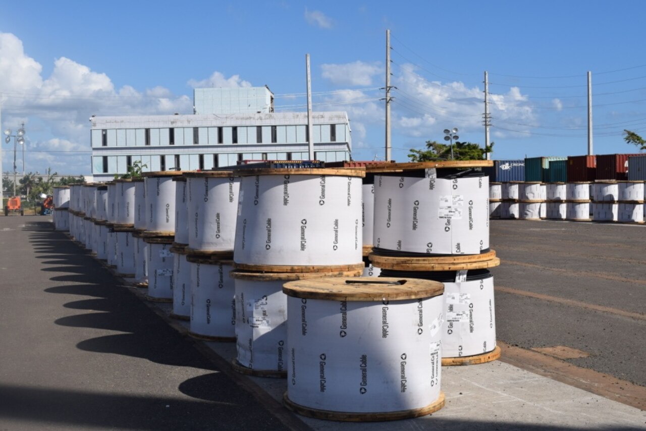 Hundreds of massive coils of heavy high tension wire arrive at the laydown yard in Ponce, Puerto Rico.