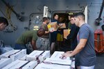 U.S. FIFTH FLEET AREA OF OPERATIONS (Dec. 22, 2017) – Marines and Sailors with USS San Diego and embarked 15th Marine Expeditionary Unit pass boxes during a replenishment at sea. San Diego, with the embarked 15th Marine Expeditionary Unit, is deployed to the U.S. 5th Fleet area of operations in support of maritime security operations to reassure allies and partners and preserve the freedom of navigation and the free flow of commerce in the region.