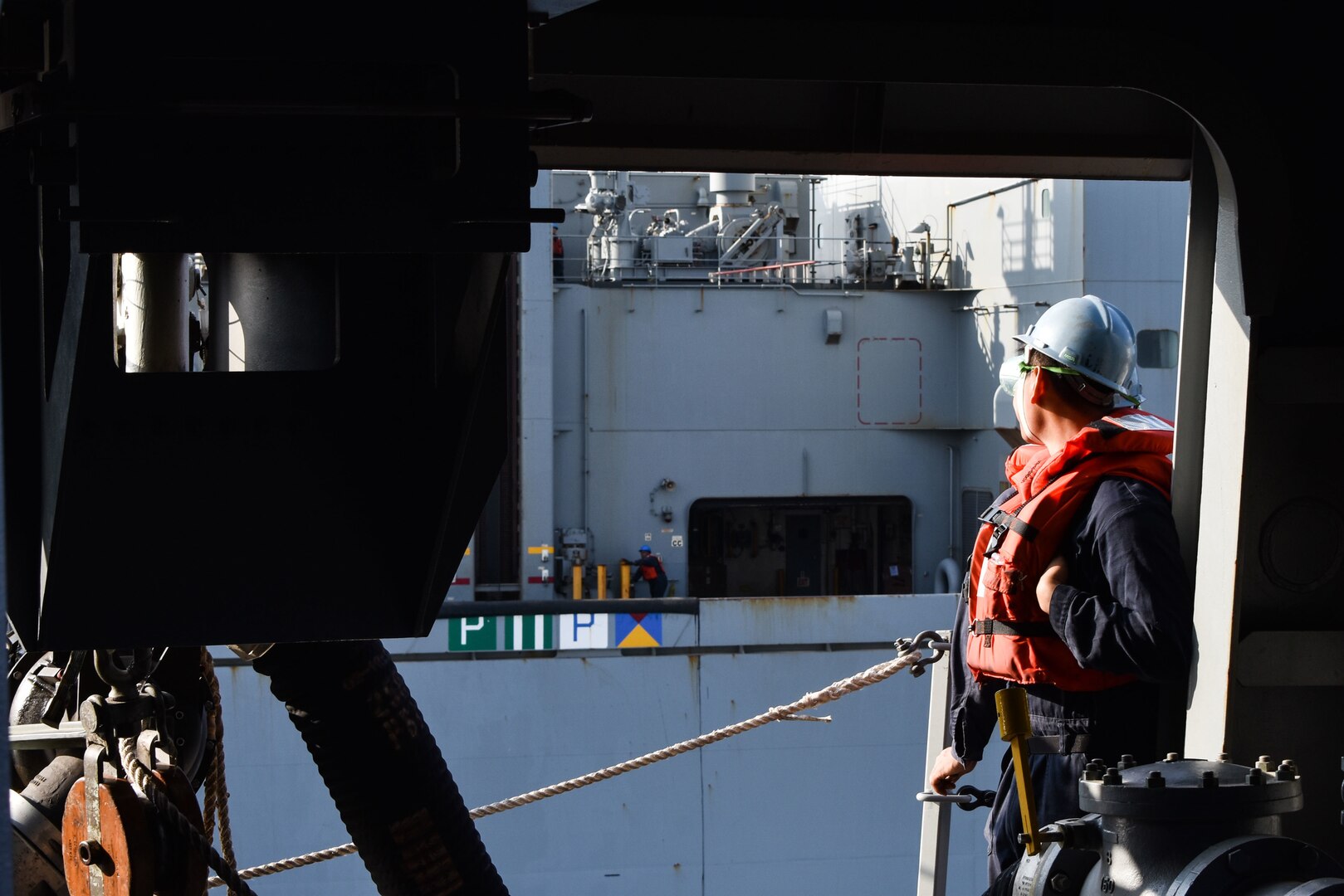U.S. FIFTH FLEET AREA OF OPERATIONS (Dec. 22, 2017) – A Sailor with USS San Diego observes USNS Washington Chambers during a replenishment at sea. San Diego, with the embarked 15th Marine Expeditionary Unit, is deployed to the U.S. 5th Fleet area of operations in support of maritime security operations to reassure allies and partners and preserve the freedom of navigation and the free flow of commerce in the region.