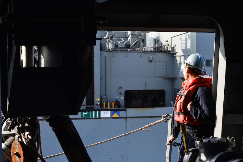 U.S. FIFTH FLEET AREA OF OPERATIONS (Dec. 22, 2017) – A Sailor with USS San Diego observes USNS Washington Chambers during a replenishment at sea. San Diego, with the embarked 15th Marine Expeditionary Unit, is deployed to the U.S. 5th Fleet area of operations in support of maritime security operations to reassure allies and partners and preserve the freedom of navigation and the free flow of commerce in the region.