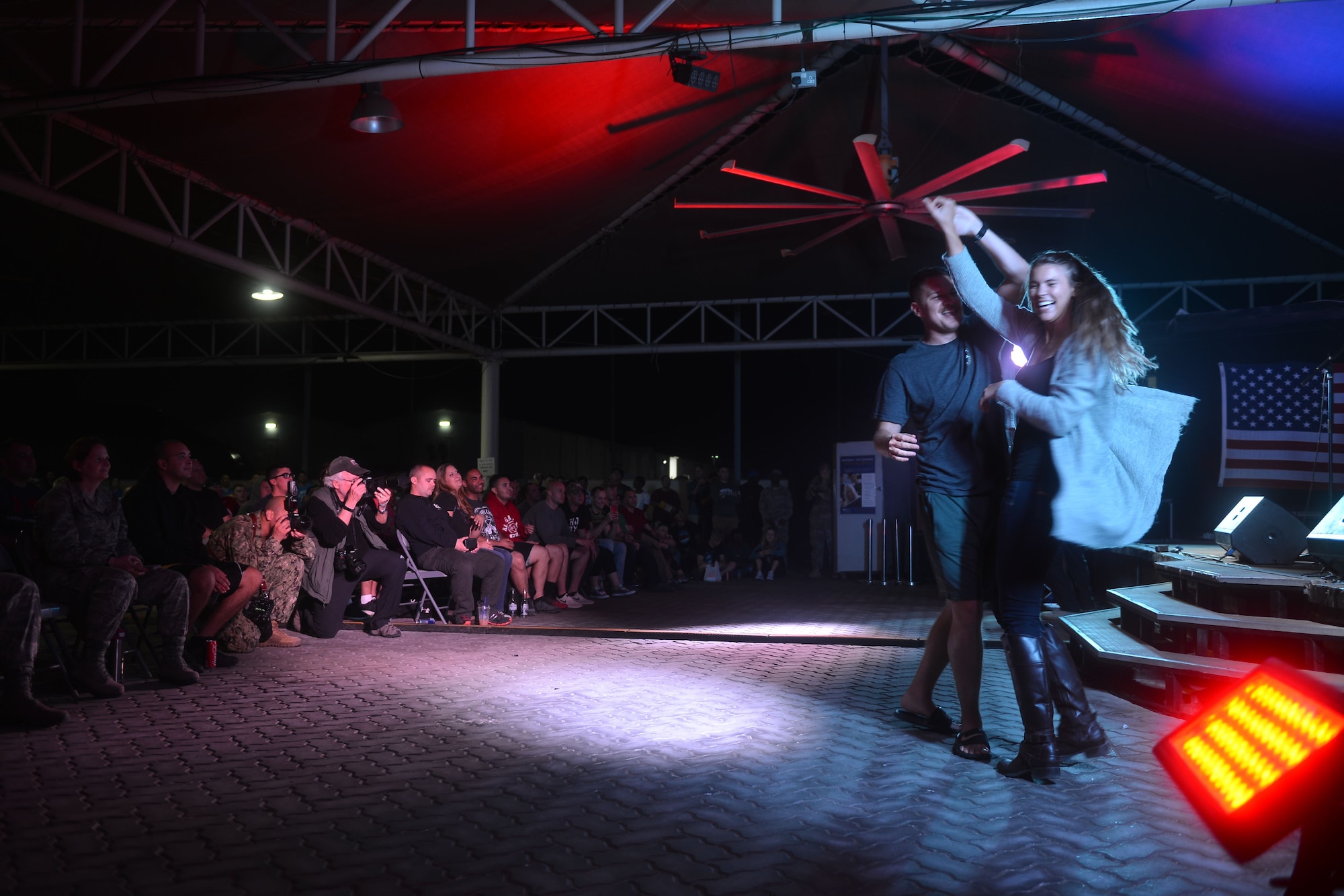 Service members dance together as singer Jerrod Niemann performs at the 380th Air Expeditionary Wing, Al Dhafra Air Base, United Arab Emirates during the 2017 Chairman's USO Holiday Tour Dec. 22, 2017.
 U.S. Marine Corps Gen. Joe Dunford, Chairman of the Joint Chiefs of Staff, hosts this tour to spread holiday cheer to service members deployed and stationed overseas. 


 (U.S. Air Force photo by Tech. Sgt. Anthony Nelson Jr.)