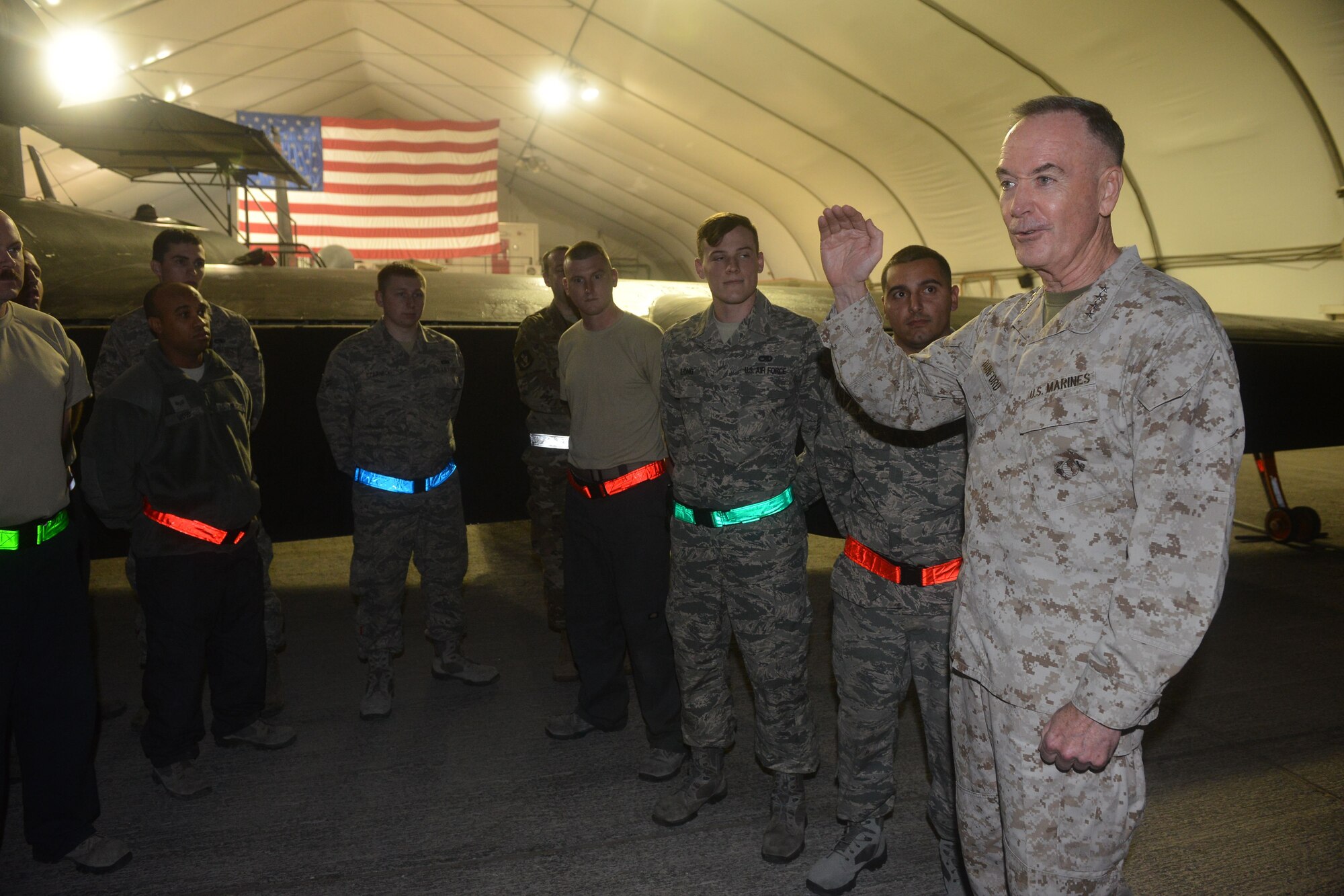 U.S. Marine Corps Gen. Joe Dunford, Chairman of the Joint Chiefs of Staff, 
 speaks to 380th Expeditionary Maintenance Group Airmen on the flightline of Al Dhafra Air Base, United Arab Emirates during the 2017 Chairman's USO Holiday Tour Dec. 22, 2017. Dunford hosts this tour to spread holiday cheer to service members deployed and stationed overseas. 

 (U.S. Air Force photo by Tech. Sgt. Anthony Nelson Jr.)