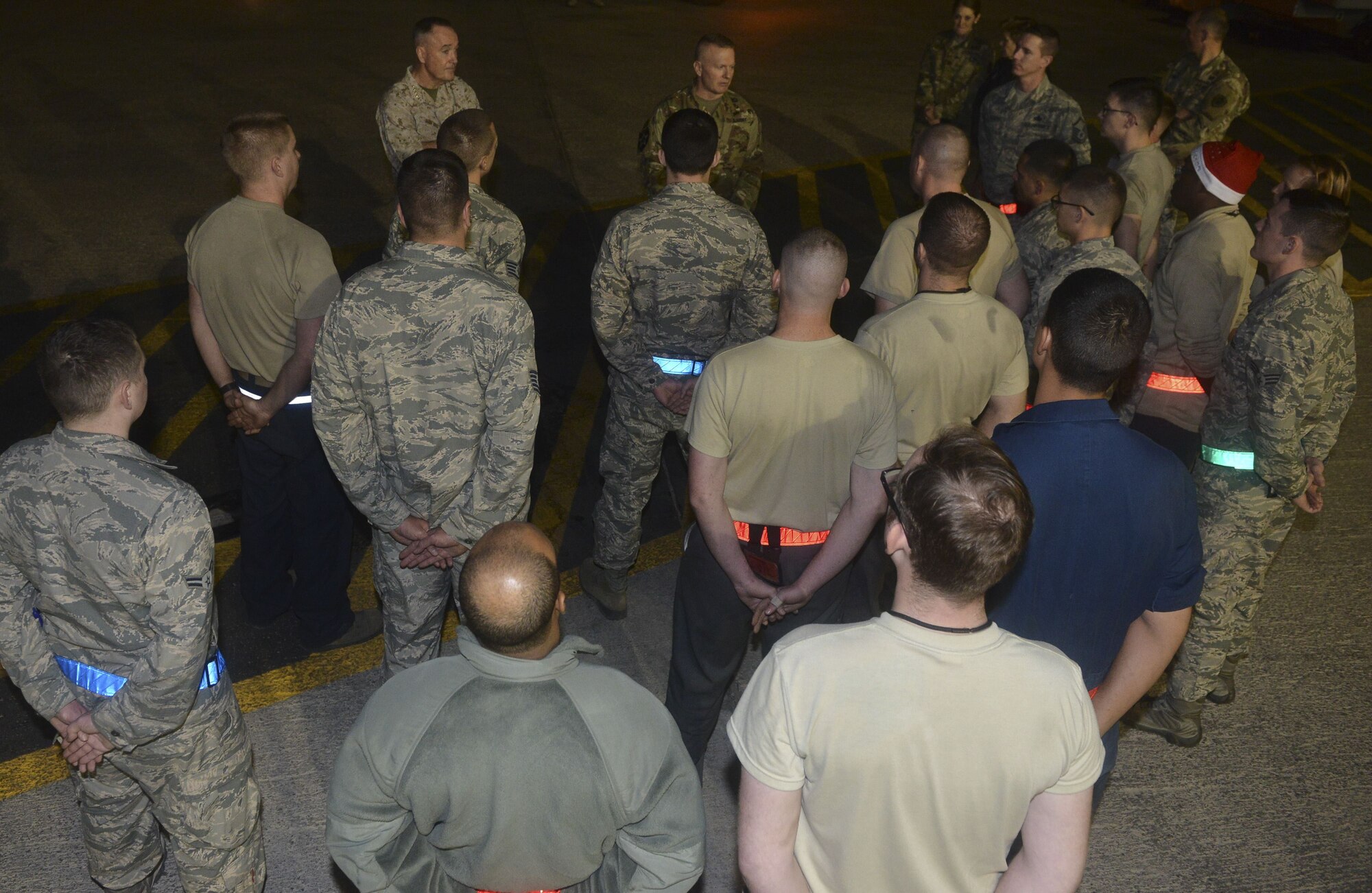 U.S. Marine Corps Gen. Joe Dunford, Chairman of the Joint Chiefs of Staff, and U.S. Army Command Sgt. Maj. John W. Troxell, senior enlisted advisor to the chairman speaks to 380th Expeditionary Maintenance Group Airmen on the flightline of Al Dhafra Air Base, United Arab Emirates during the 2017 Chairman's USO Holiday Tour Dec. 22, 2017. Dunford hosts this tour to spread holiday cheer to service members deployed and stationed overseas. 

 (U.S. Air Force photo by Tech. Sgt. Anthony Nelson Jr.)