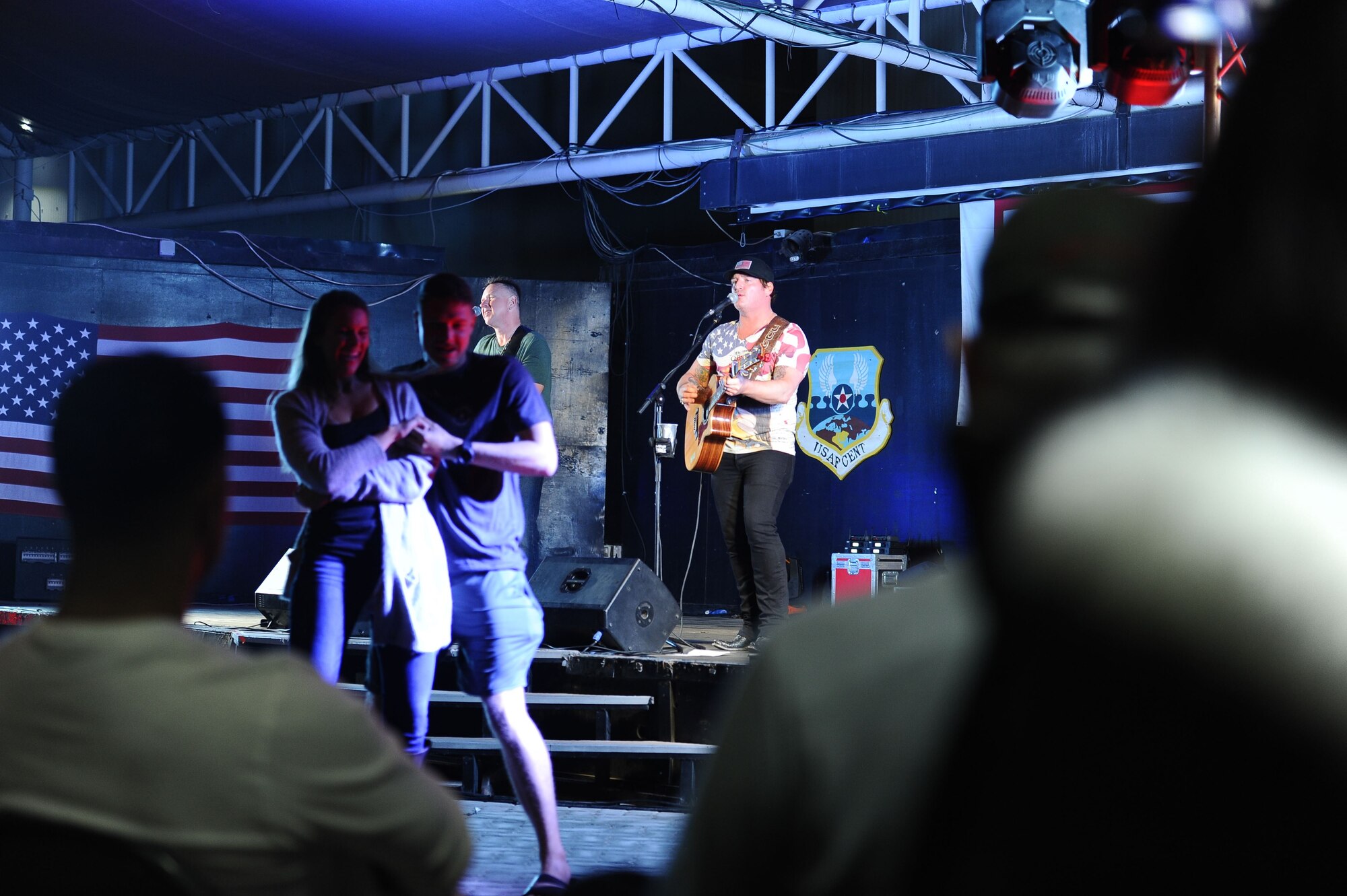 Service members dance together as singer Jerrod Niemann performs at the 380th Air Expeditionary Wing, Al Dhafra Air Base, United Arab Emirates during the 2017 Chairman's USO Holiday Tour Dec. 22, 2017.
 U.S. Marine Corps Gen. Joe Dunford, Chairman of the Joint Chiefs of Staff, hosts this tour to spread holiday cheer to service members deployed and stationed overseas. 


 (U.S. Air Force photo by Tech. Sgt. Anthony Nelson Jr.)