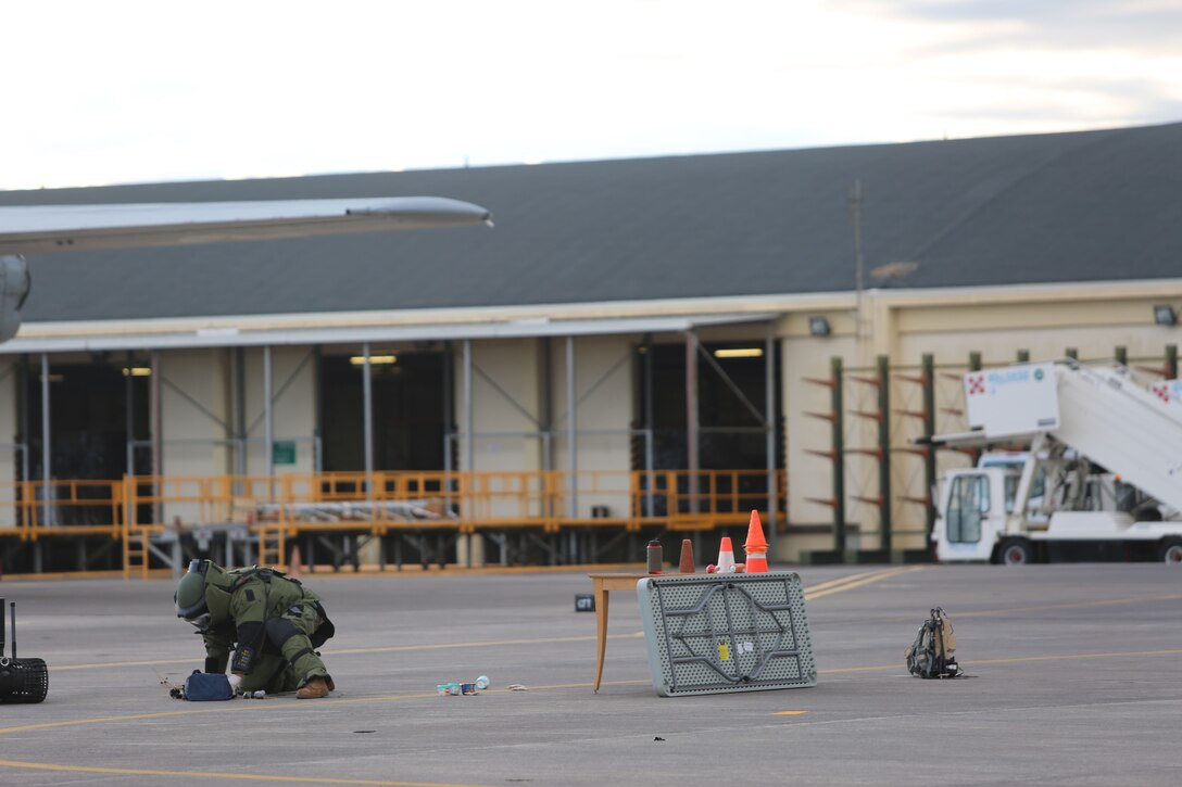 An Explosive Ordnance Disposal technician assigned to Special Purpose Marine Air-Ground Task Force-Crisis Response-Africa inspect suspicious luggage during non-combatant evacuation operation training aboard Naval Air Station Sigonella, Italy, on Nov. 17, 2017. SPMAGTF-CR-AF deployed to conduct limited crisis-response and theater-security operation in Europe and Africa. (U.S. Marine Corps photo by Lance Cpl. Patrick Osino)