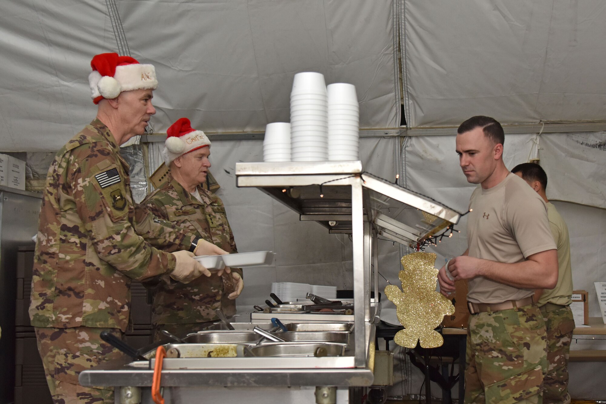 U.S. Air Force Lt. Gen. Scott Rice, Air National Guard director, and Chief Master Sgt. Ronald Anderson Jr., ANG command chief, serve Christmas lunch at the 407th Air Expeditionary Group in Southwest Asia, Dec. 25, 2017. They visited the 407th AEG to spend Christmas with Airmen. (U.S. Air Force photo by Staff Sgt. Joshua Edwards/Released)