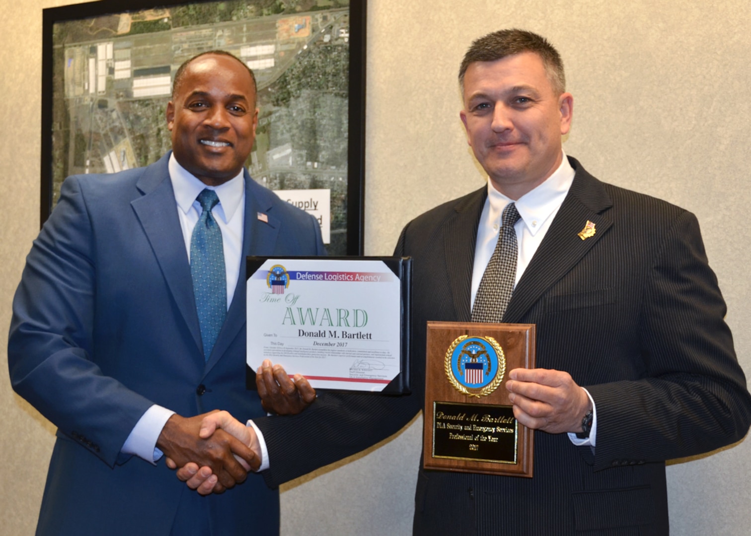 Donald Bartlett (right) receives the first Security Professional of the Year Award from Patrick Wright, staff director of Security and Emergency Services at DLA HQ.