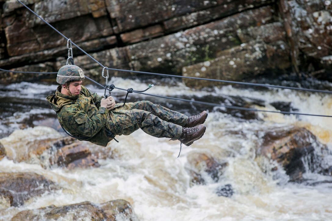 U.S. Marine with Marine Rotational Force Europe (MRF-E) crosses a river using a zip-line during exercise Green Claymore in Strathgarve, Scotland, Nov. 26, 2017. Green Claymore is a pre-Arctic training course lead by the British Royal Marines, designed to improve mountaineering and cold weather survival skills. (U.S. Marine Corps photo by Cpl. Careaf L. Henson/Released)