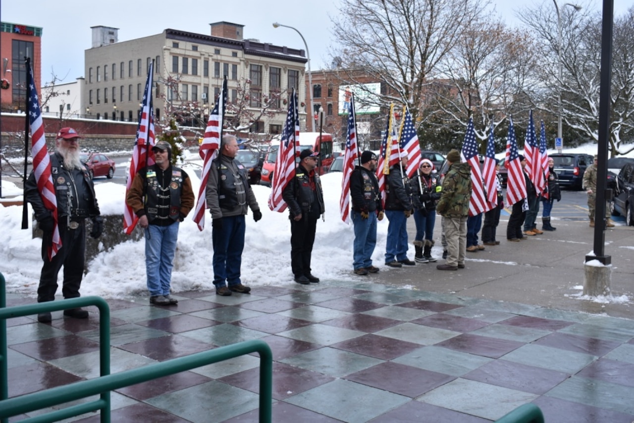 Military veterans display American flags in downtown Glens Falls, N.Y.