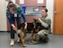 Dr. Heather Graves, 9th Aerospace Medicine Squadron veterinarian, inspects a military working dog’s tail while Staff Sgt. Taylor Song, 9th Security Forces MWD handler, keeps him still