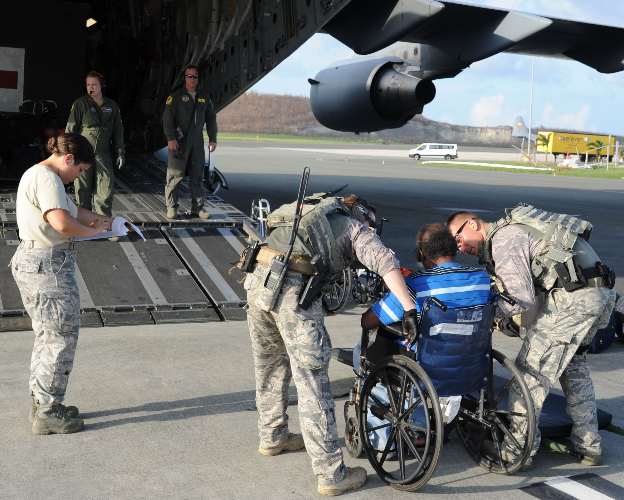 Reserve Citizen Airmen assigned to the 45th Aeromedical Evacuation Squadron, assist a patient aboard a C-17 Globemaster III in St. Croix, U.S. Virgin Islands, Sept. 24, 2017. Reserve Citizen Airmen conduct humanitarian mission to St. Croix to evacuate victims affected by Hurricane Maria. (U.S. Air Force photo by Tech. Sgt. Peter Dean)