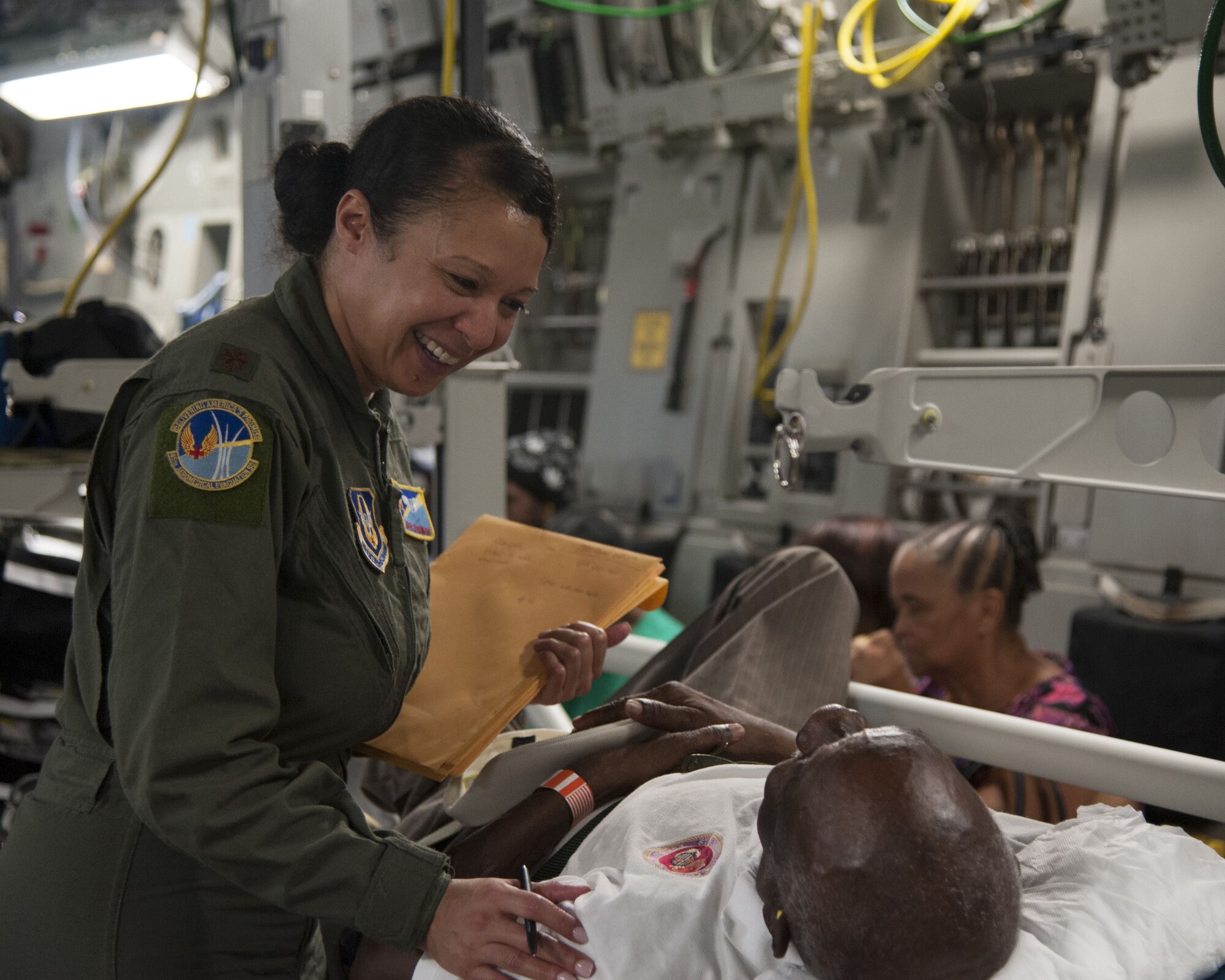 U.S. Air Force Maj. Gavril Goodman assigned to the 45th Aeromedical Evacuation Squadron, comforts a patient aboard a C-17 Globemaster III while enroute from St. Croix to Dobbins Air Reserve Base, Ga., Sept. 24, 2017. Reserve Citizen Airmen conducted humanitarian missions to St. Croix to evacuate victims affected by Hurricane Maria. (U.S. Air Force photo by Tech. Sgt. Peter Dean)