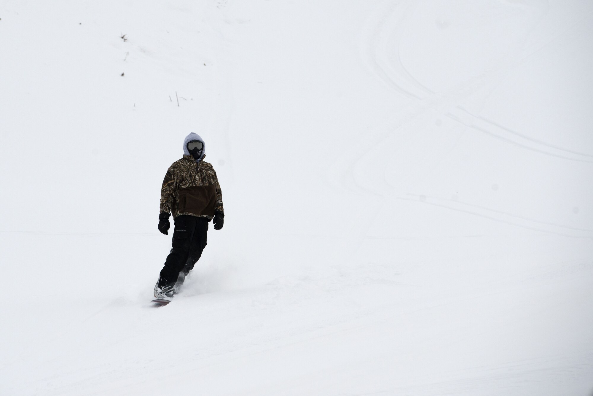 Airman 1st Class Zachary Rayfield, 673d Civil Engineer Squadron fire fighter, snowboards down Hillberg Ski Area during Winterfest at Joint Base Elmendorf-Richardson, Alaska, Dec. 21, 2017. Winterfest was a winter solstice celebration hosted by Hillberg for anyone with base access and offered a plethora of events from noon to as late at 8 p.m.
