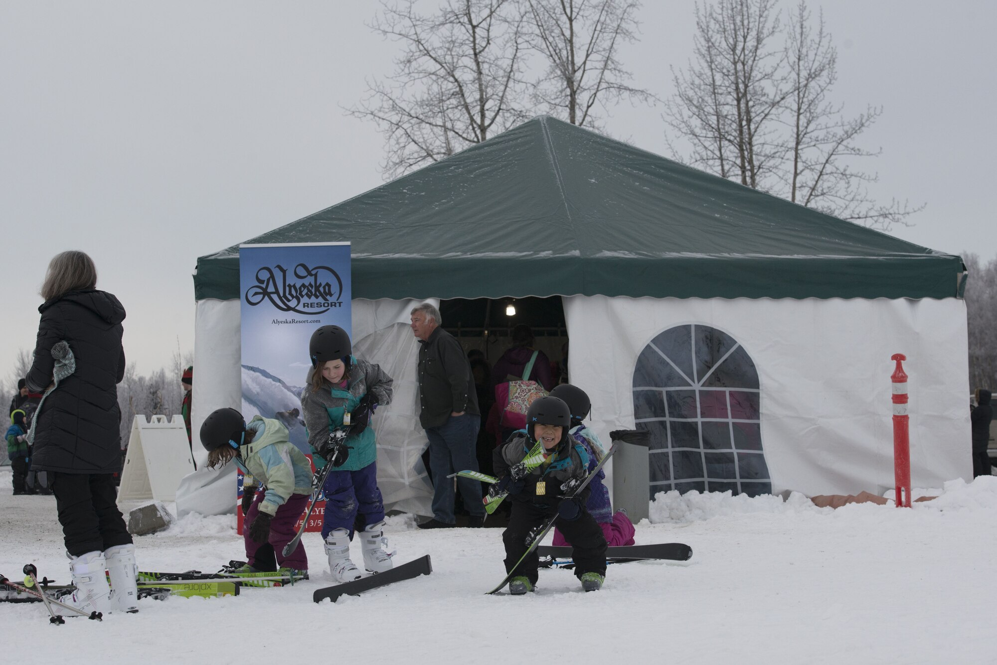 Children put on their skis outside a concessions tent at the Hillberg Ski Area during Winterfest at Joint Base Elmendorf-Richardson, Alaska, Dec. 21, 2017. Winterfest was a winter solstice celebration hosted by Hillberg for anyone with base access and offered a plethora of events from noon to as late at 8 p.m.