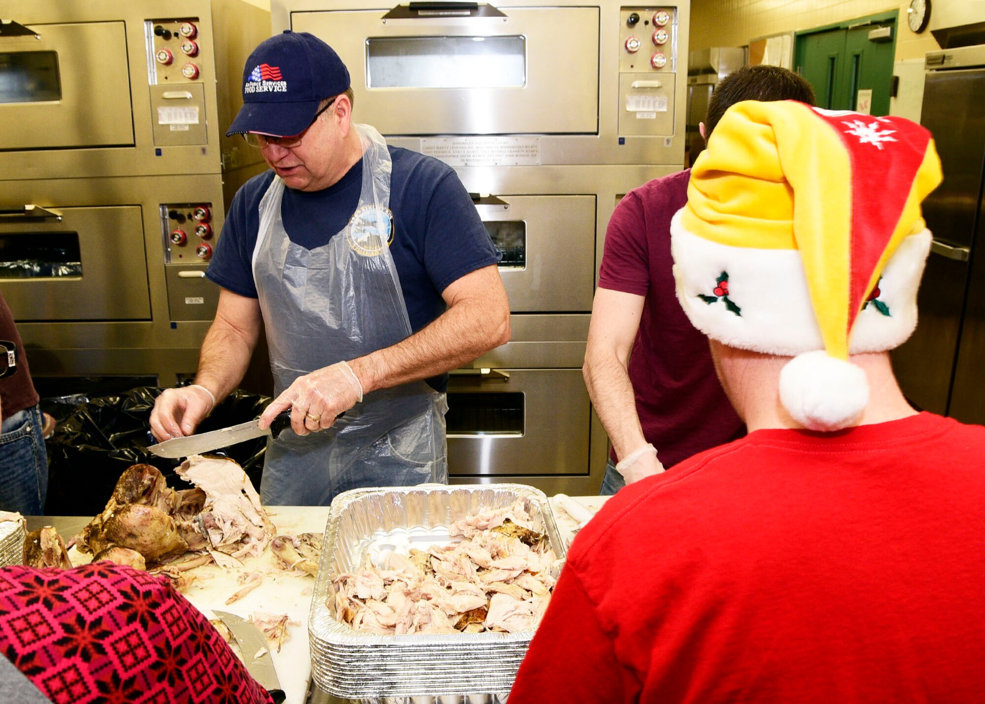 120th Airlift Wing Command Chief Master Sgt. Steven Lynch carves a turkey at the 120th Airlift Wing Dining Facility at the Great Falls International Airport in Great Falls, Montana Dec. 24, 2017. Montana Air National Guard personnel volunteered to prepare 50 turkeys, dressing and gravy and delivered the food to the Great Falls Senior Citizen Center to be served during the 25th Annual Danny Berg Memorial Christmas Dinner. (U.S. Air National Guard photo/Senior Master Sgt. Eric Peterson)