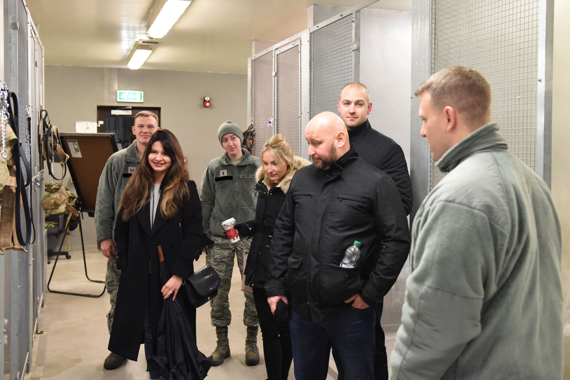 Guest speakers from U.K. universities receive a tour of the 48th Security Forces Squadron military working dog kennel at Royal Air Force Feltwell, England, Dec. 11. The doctors spoke to Sexual Assault Prevention and Response personnel and victim advocates about sexual assault, child abuse and suicide prevention. (U.S. Air Force photo / Airman 1st Class John A. Crawford)