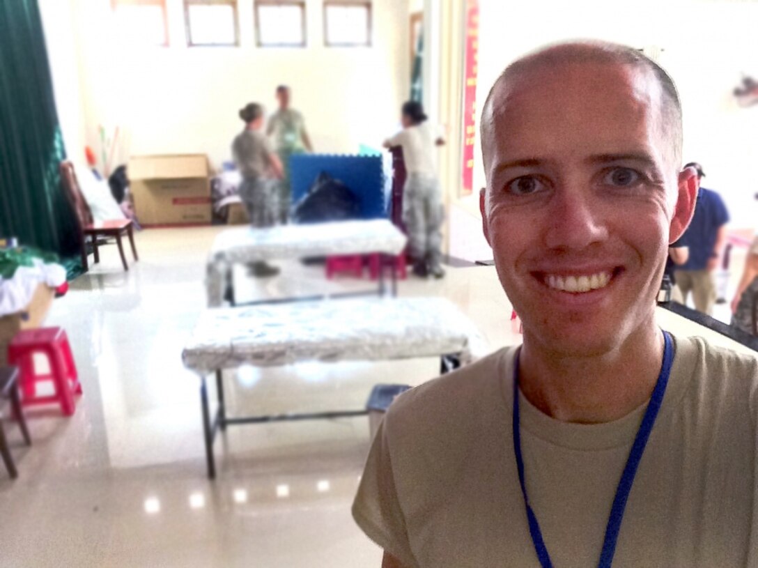 Air Force Maj. (Dr.) Cody Butler, a physical therapist and commander of the 78th Medical Group Clinical Medicine Flight, poses in the clinic set up in the government community center in Tam Ky, Quang Nam Province, Vietnam, Nov. 30, 2017. Butler was in Vietnam as part of a team seeing patients and building relationships with local physicians during the humanitarian assistance engagement Operation Pacific Angel Vietnam 2017. Air Force photo by Jonathan Bell