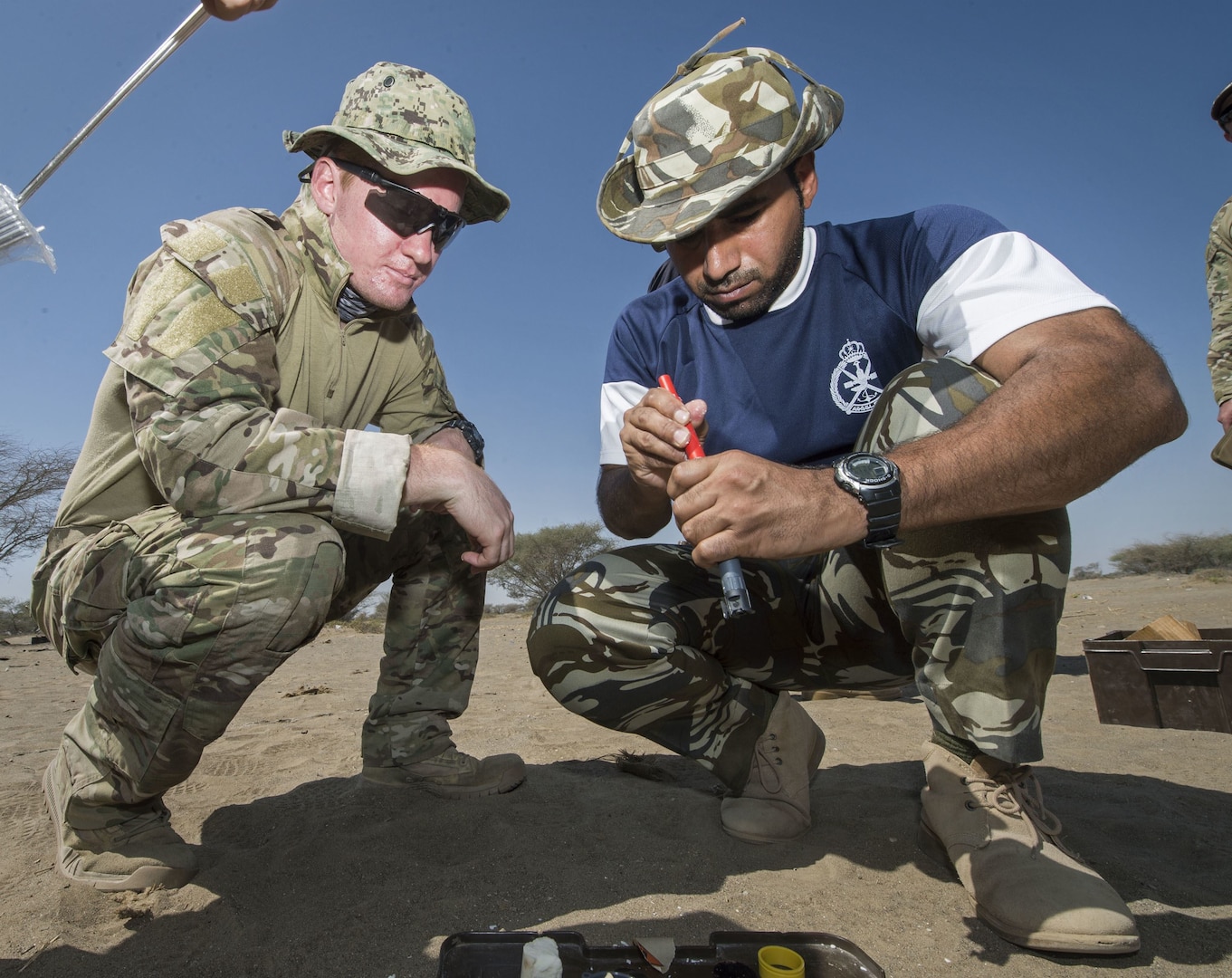 Explosive Ordnance Disposal Technician 3rd Class Ben Holden, left, assigned to Task Group 56.1, and a member of the Royal Navy of Oman prepare explosives during Exercise Safe Handling 2017. (U.S. Navy photo by Mass Communication Specialist 2nd Class Sean Furey)