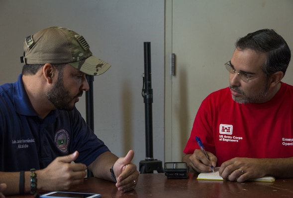 Omar Esquilin-Mangual meets with a local resident while working the Blue Roof mission in Puerto Rico.
