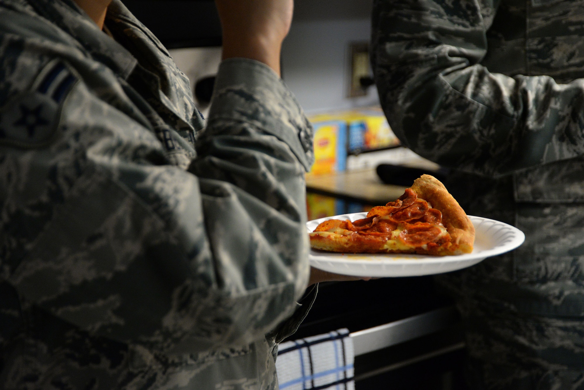 Airman 1st Class Patricia Hebert, 81st Engineering Installation Squadron radio frequency transmissions technician, eats pizza during the Haven reopening Dec. 21, 2017, on Keesler Air Force Base, Mississippi. Keesler’s private organizations came together to remodel and reopen the Haven to improve the dorm common area for Keesler’s dorm residents. (U.S. Air Force photo by Airman 1st Class Suzanna Plotnikov)