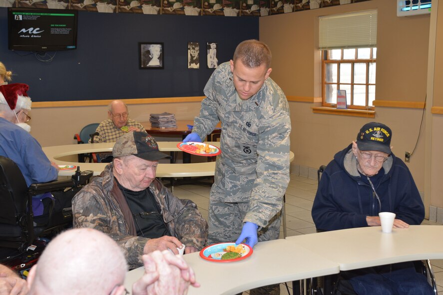 Members of the 507th Air Refueling Wing at Tinker Air Force Base, Okla., visit the Norman Veterans Center Dec. 21, 2017, to spread holiday cheer with residents in Norman, Okla. For 22 years, the 507th ARW has sponsored veterans during the holidays as part of the Angel Tree program. This year, 28 veterans received nearly 2,000 dollars in gifts from wing members. (U.S. Air Force photo/Tech. Sgt. Lauren Gleason)