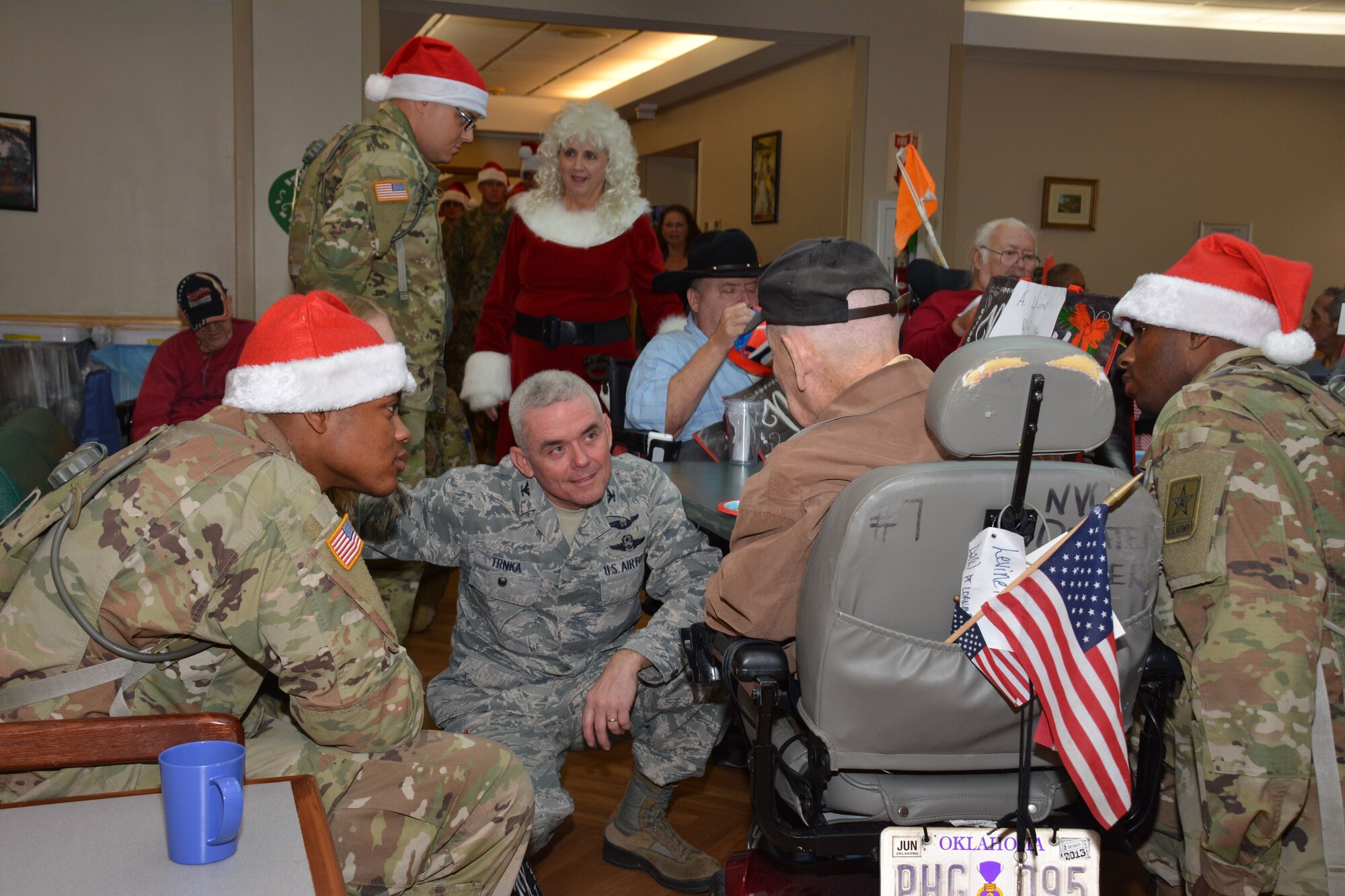 Members of the 507th Air Refueling Wing at Tinker Air Force Base, Okla., visit the Norman Veterans Center Dec. 21, 2017, to spread holiday cheer with residents in Norman, Okla. For 22 years, the 507th ARW has sponsored veterans during the holidays as part of the Angel Tree program. This year, 28 veterans received nearly 2,000 dollars in gifts from wing members. (U.S. Air Force photo/Tech. Sgt. Lauren Gleason)