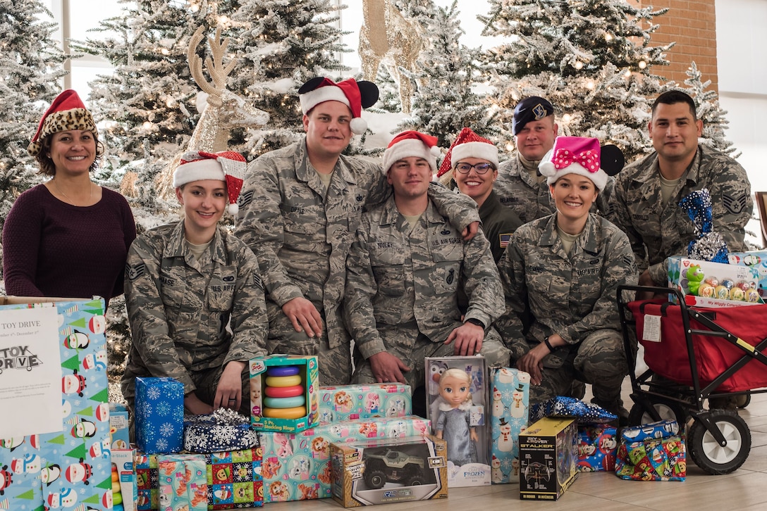 Volunteer Junior Enlisted Council Airmen from Will Rogers Air National Guard Base, Okla., pose with gifts ready to be delivered to children at INTEGRIS Baptist Health Center, Oklahoma City, Dec. 15, 2017. Pictured (from left to right) are Master Sgt. Nongh Lee Kastor, Staff Sgt. Jaimie Haase, Staff Sgt. Kyle Drake, Staff Sgt. Jared Tooley, Staff Sgt, Sarah Bell, Tech. Sgt. Ryan DeLarber, Airman 1st Class Brooke Evans and Staff Sgt. David Carrillo. The JEC collected toys in the months leading up to December and distributed them to families who would be at the hospital over the holidays. (U.S. Air National Guard photo by Senior Airman Brigette Waltermire/Released)