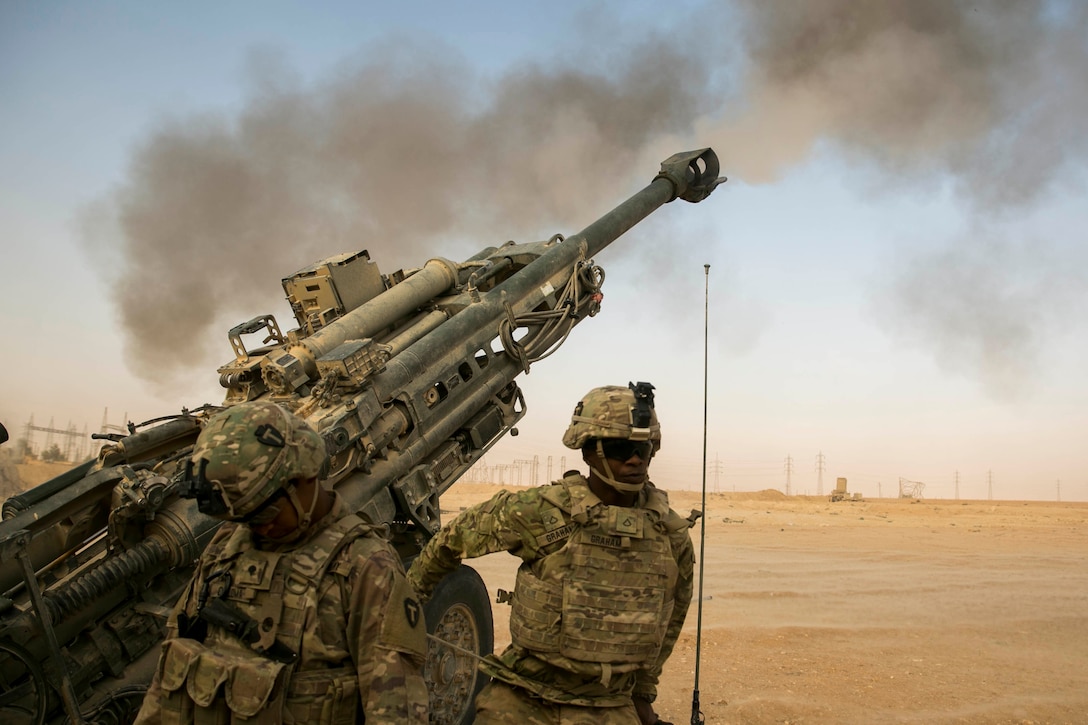 American artillery soldiers respond to a fire mission somewhere in Iraq.