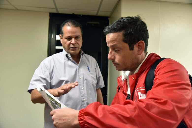 Bayamon Vice Mayor Rurico Pintado Cruz and U.S. Army Corps of Engineers Task Force Power Restoration Real Estate Chief Eric Sternberg discuss the location of potential city land space at the sports complex in Bayamon, Puerto Rico, Dec. 22. The task force sought property for the storage of critical materials used in the power restoration mission, including utility poles and other power grid supplies. The city is allowing the Corps use of its property and infrastructure to help expedite delivery of needed power grid supplies and equipment across the island.