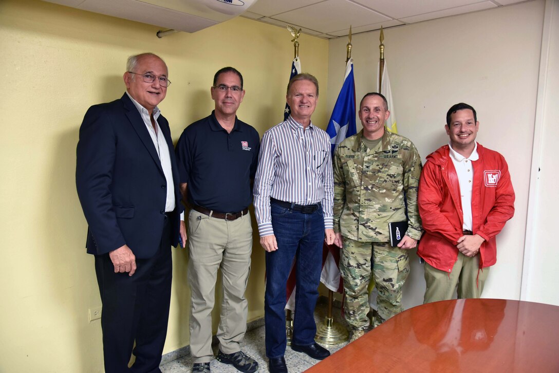 Attorney Eliezer Aldarondo, USACE Puerto Rico Power Grid Program Director Jose Sanchez, Bayamon City Mayor Ramon L. Rivera Cruz, Task Force Power Restoration Commander Col. John Lloyd and Real Estate Chief Eric Sternberg meet Dec. 22 in Bayamon, Puerto Rico, to discuss use of city land space at the Bayamon sports complex for storage of critical materials used in the power restoration mission, including utility poles and other power grid supplies. The city is allowing the Corps use of its property and infrastructure to help expedite delivery of needed power grid supplies and equipment across the island.