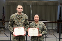 Staff Sergeant Jordan Jeffries (Left) stands alongside Sgt Jasmine Gonzalez (Right) presenting their Navy and Marine Corps Achievement Medals for being the fiscal year 2017 Recruiter and Rookie Recruiter of the Year of Recruiting Station Indianapolis.